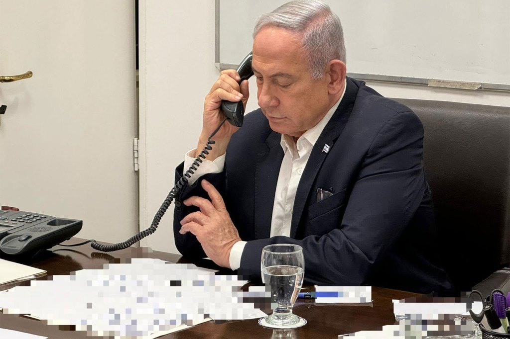 Israeli Prime Minister Benjamin Netanyahu in a suit, holding a phone to his ear