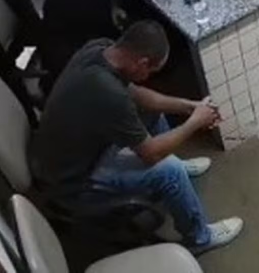 Francisco Cleidivaldo Mariano De Moura is seen sitting with his head down moments before being shot at in the courtroom.