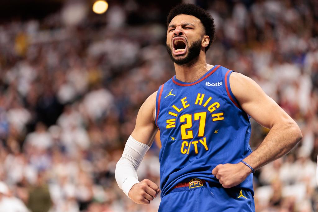 Jamal Murray celebrates after slamming home a dunk during the Nuggets' win.  