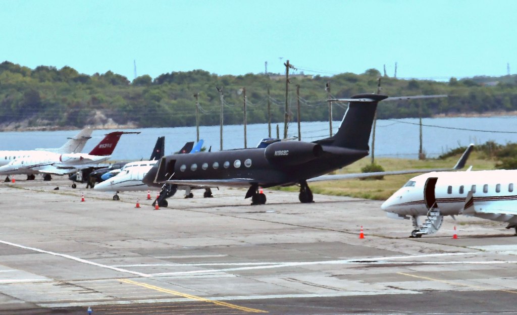 Diddy's black Gulfstream 5 private jet parked on a runway at St John's Airport in Antigua