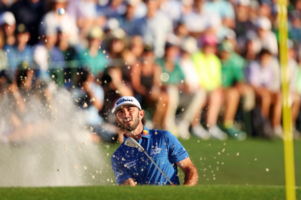 Max Homa hits a bunker shot on the 18th hole during the third round of the Masters.