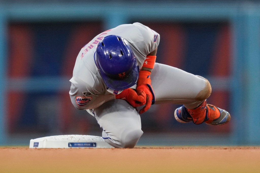 New York Mets' Francisco Alvarez reacts to an injury on second base during the second inning of a baseball game against the Los Angeles Dodgers