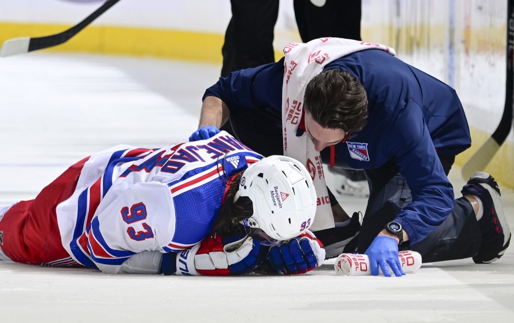 Mika Zibanejad lies on the ice after colliding with Adam Pelech during the Rangers' 4-2 loss to the Islanders.