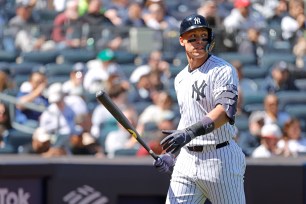 Aaron Judge #99 of the New York Yankees reacts as he walks back to the dugout after he strikes out swinging during the 4th inning.