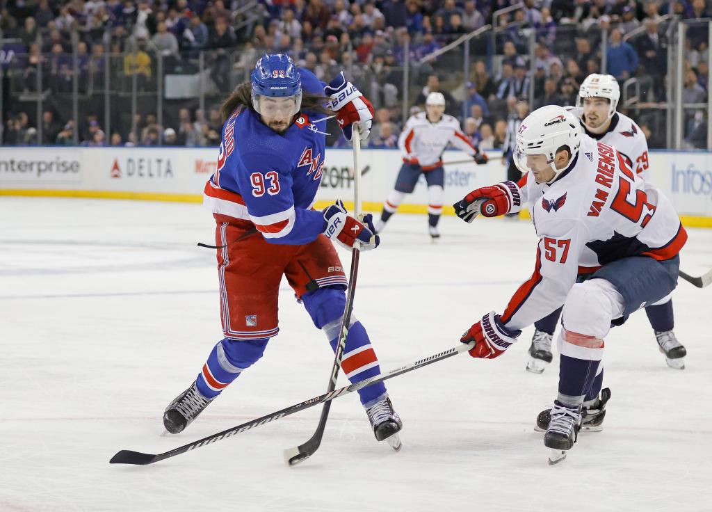 Mika Zibanejad  takes a shot on goal as Washington Capitals defenseman Trevor van Riemsdyk defends during the first period. 