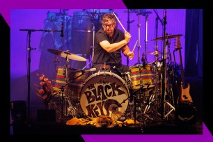Black Keys drummer Patrick Carney bangs on his kit in concert.