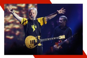 Bachman-Turner Overdrive frontman Randy Bachman gestures toward the crowd.