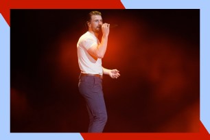 Sam Hunt croons onstage in concert.