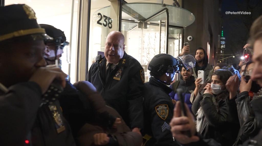 Video shows NYPD Assistant Chief James McCarthy and his officers being chased and surrounded by protestors on Monday night while trying to get inside the NYU Catholic Center after arresting one of them.