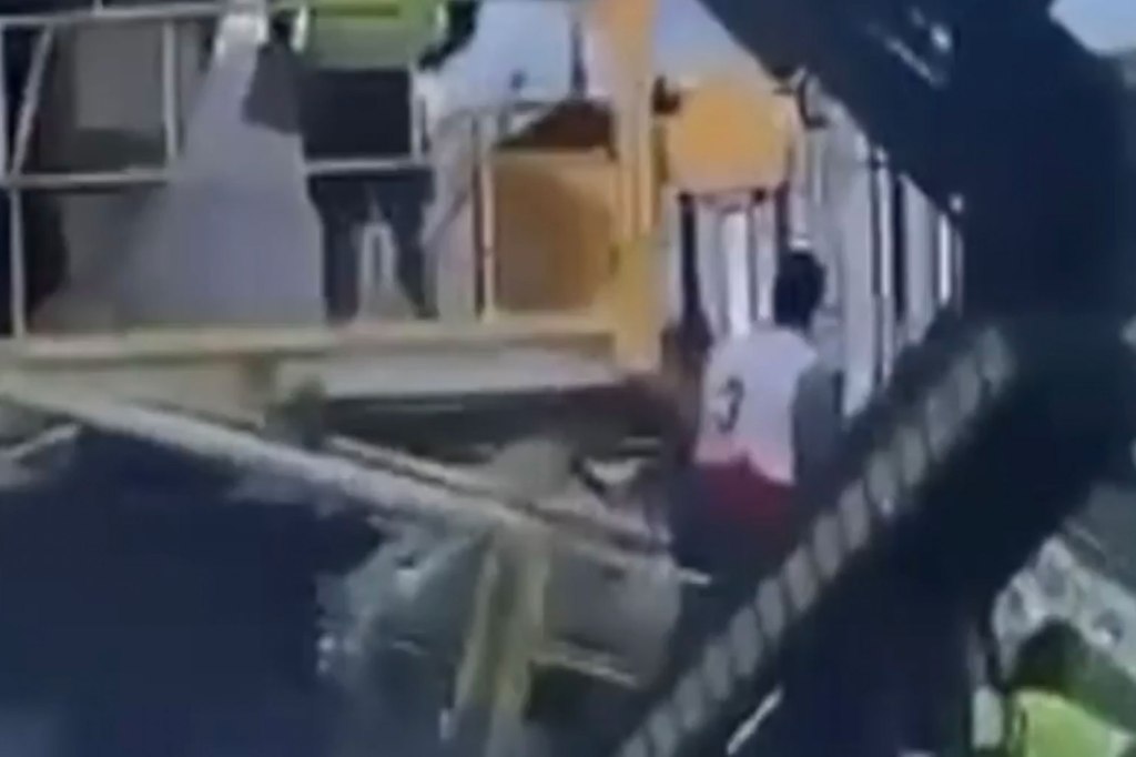 The man is seen approaching baggage handlers loading up a plane.