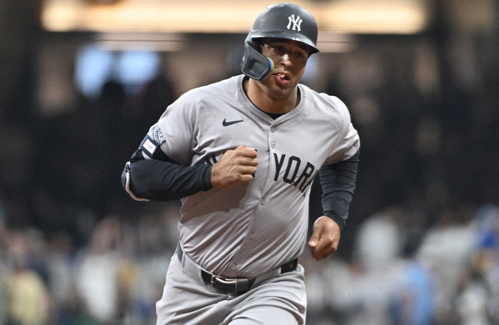 Trent Grisham rounds the bases after hitting a three-run homer in the fourth inning of the Yankees' 7-6, 11-inning loss to the Brewers.