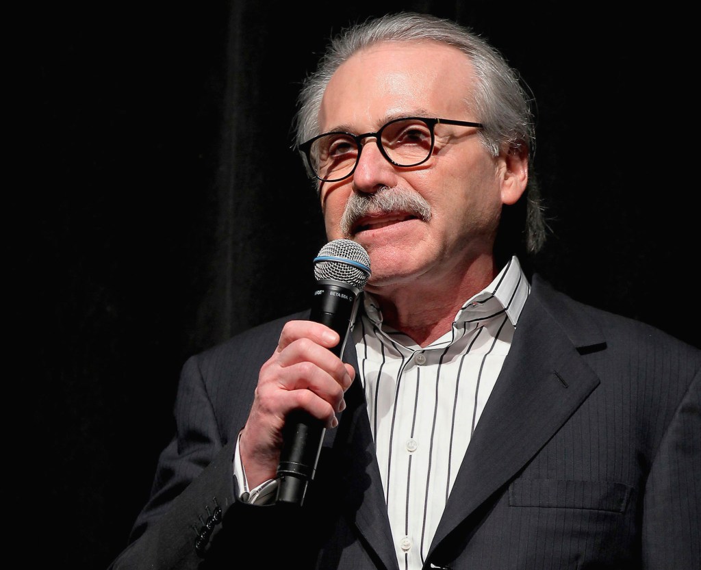 David Pecker, CEO of American Media, speaking at an event in New York, January 31, 2014, holding a microphone