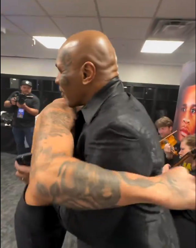 Ryan Garcia and Mike Tyson hug.