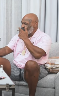 Mike Tyson smoking in a video on his strain reviews channel.