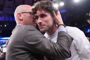 UConn coach Dan Hurley and son, Andrew, share a moment following their win over Marquette in the Big East Tournament on March 16 at the Garden.