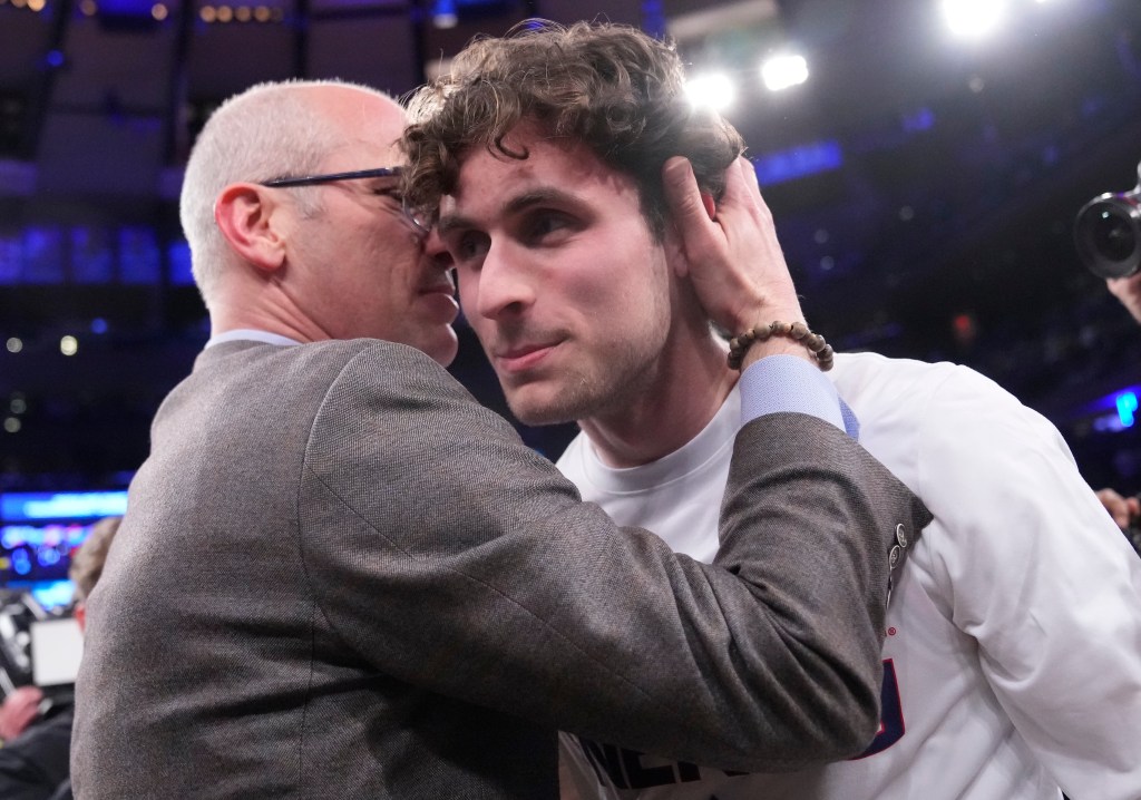 UConn coach Dan Hurley and son, Andrew, share a moment following their win over Marquette in the Big East Tournament on March 16 at the Garden.