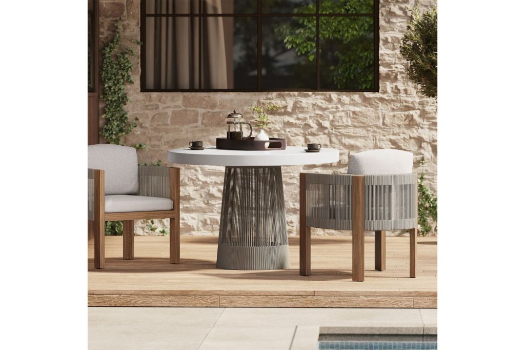 A round concrete outdoor  table with chairs.