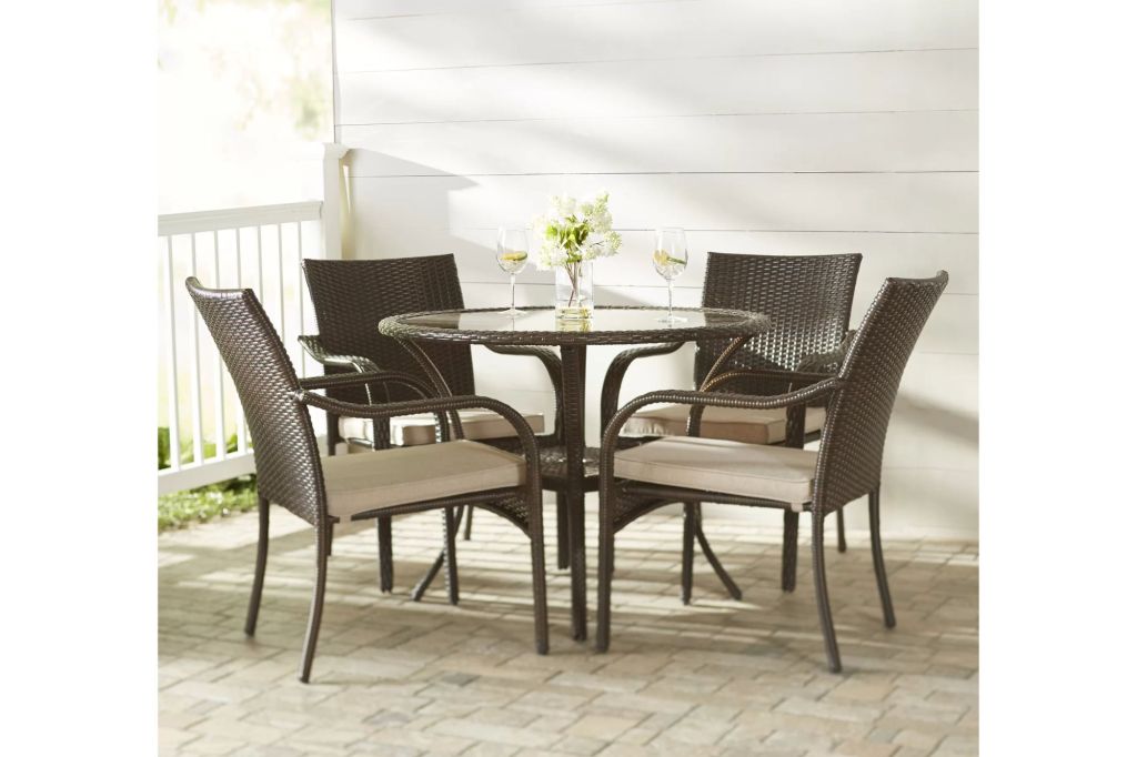 A outdoor wicker table and matching chairs.