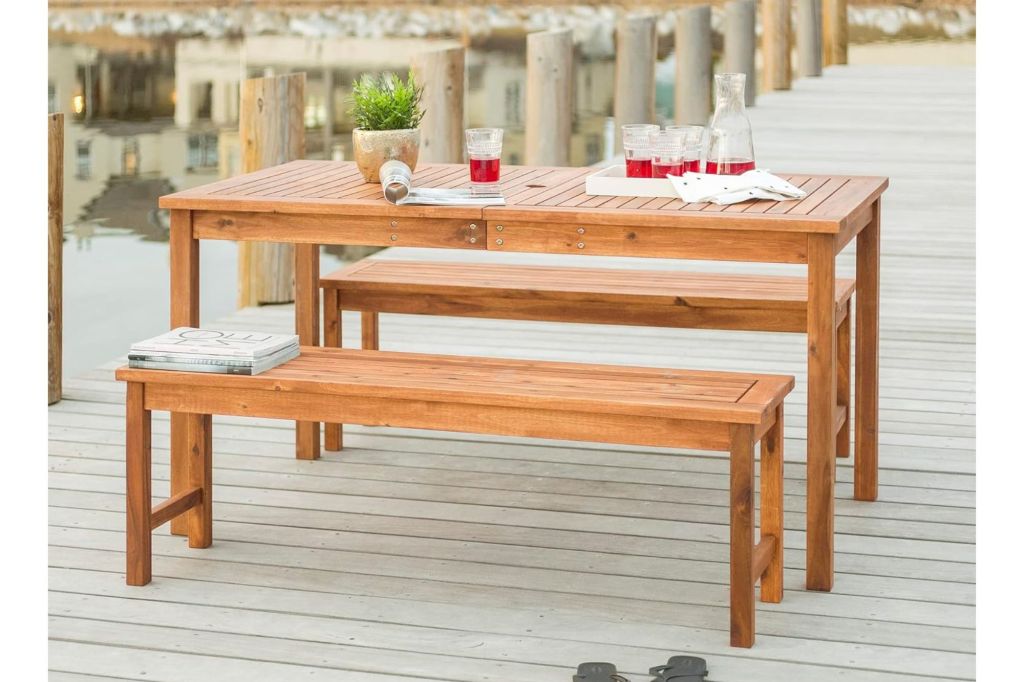 A table and benches set up for dining on a deck