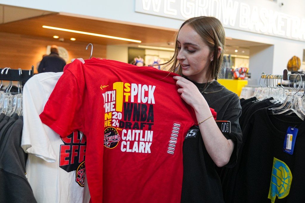 Shelby Tekulve, 20, displays one of the Caitlin Clark shirts she was purchasing in the Indiana Fever team store in Indianapolis, Tuesday, April 16, 2024. The Fever selected Clark as the No. 1 overall pick in the WNBA basketball draft.