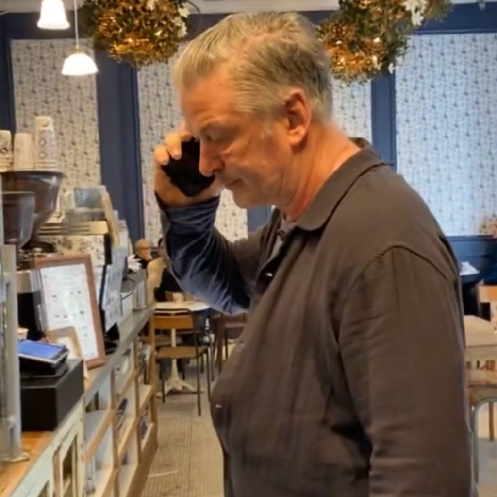 Alec Baldwin inside the coffee shop as the protester speaks to him