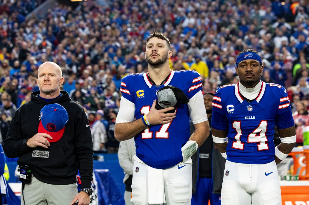 Buffalo Bills head coach Sean McDermot, Josh Allen #17 and Stefon Diggs #14 stand for the national anthem before the game against the Dallas Cowboys.