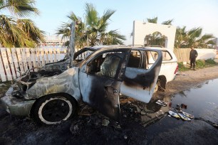 A person looks at a vehicle where employees from the World Central Kitchen (WCK), including foreigners, were killed in an Israeli airstrike.