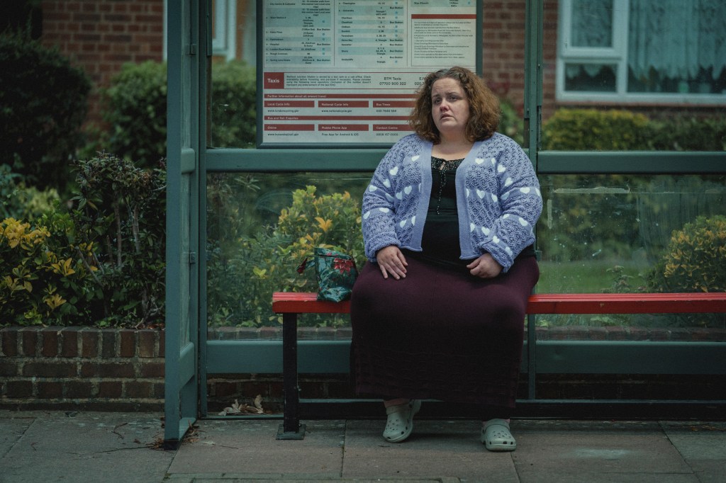 Jessica Gunning sitting on a bench. 