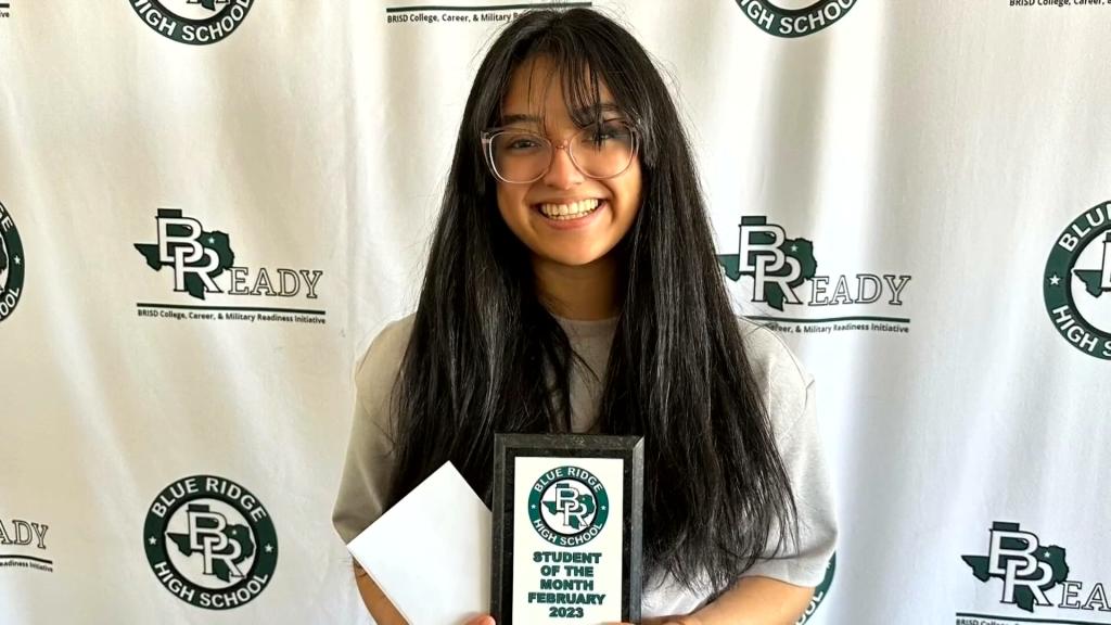 Maya Veliz holding "student of the month" award