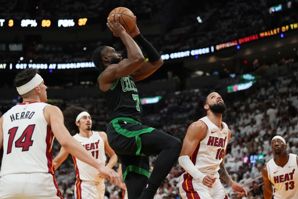 Boston Celtics guard Jaylen Brown (7) takes a shot over Miami Heat forward Caleb Martin (16) in the first half