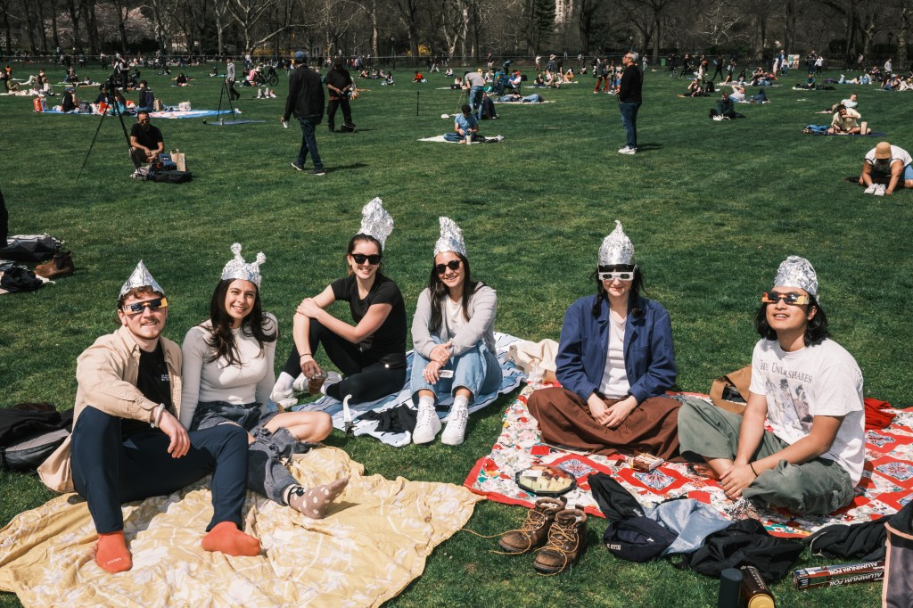A group watching the eclipse while wearing tin foil hats.