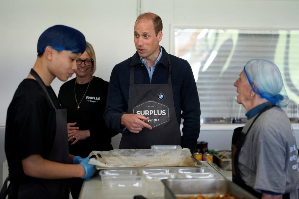 Prince William, Duke of Cambridge, engaging with workers during a visit to Surplus to Supper, a surplus food redistribution charity, in Surrey, Britain.