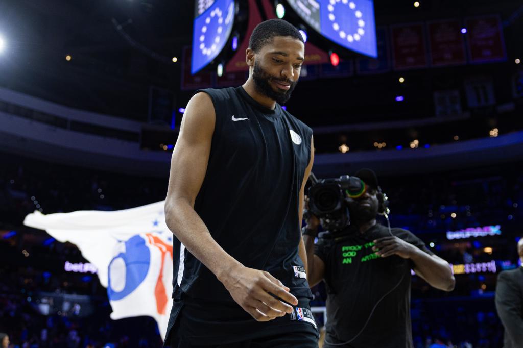 Brooklyn Nets forward Mikal Bridges in black tank top walking off the basketball court after a game against the Philadelphia 76ers