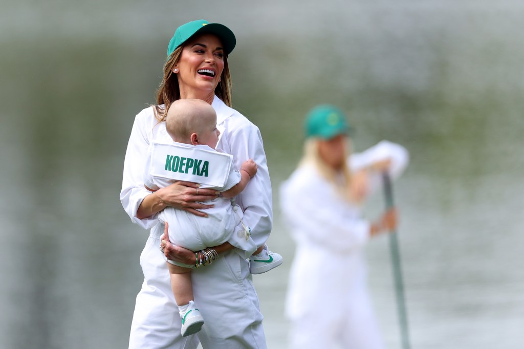 Jena Sims smiles at Augusta National while holding son Crew.