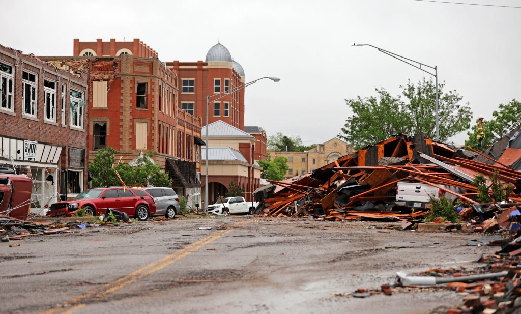 A collapsed building blocking a street in Sulphur.