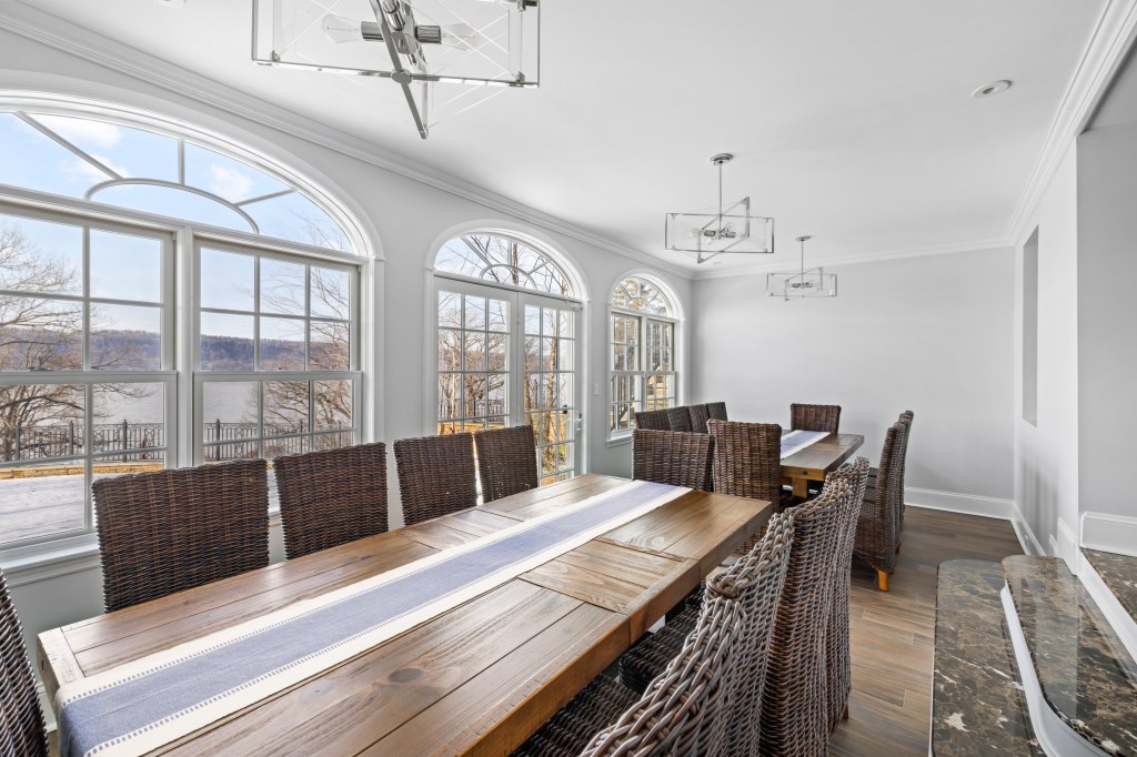A formal dining space comes with prime views of the Hudson River.