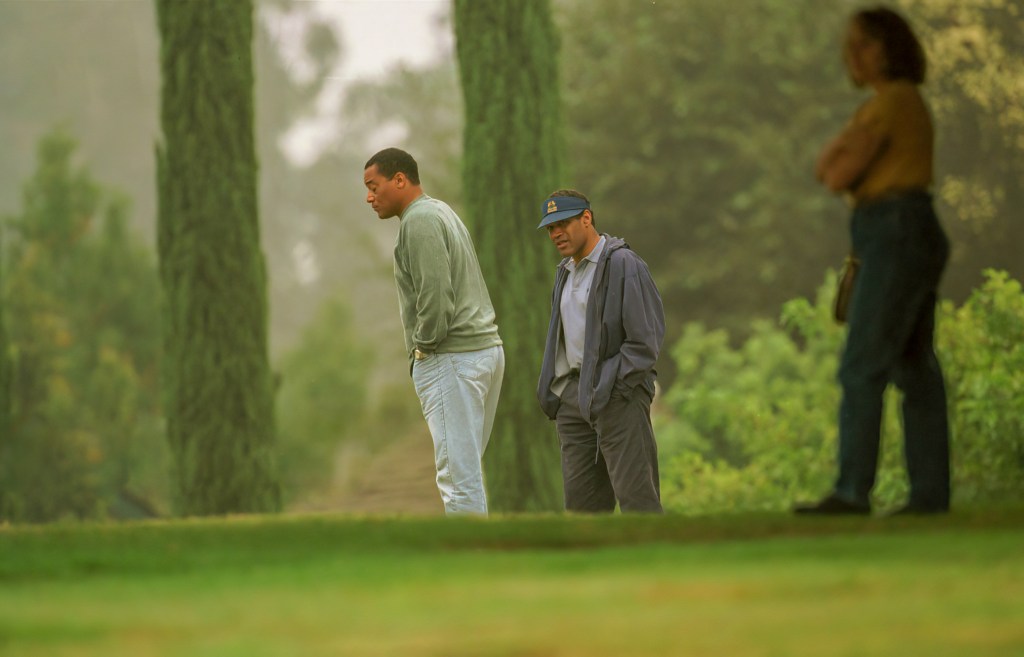 O.J. Simpson and A.C. Cowlings visiting the grave of Nicole Brown Simpson in Los Angeles, California on October 22, 1995.