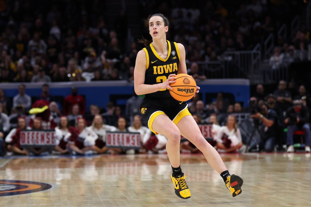 Caitlin Clark #22 of the Iowa Hawkeyes holding a basketball during the 2024 NCAA Women's Basketball Tournament National Championship game