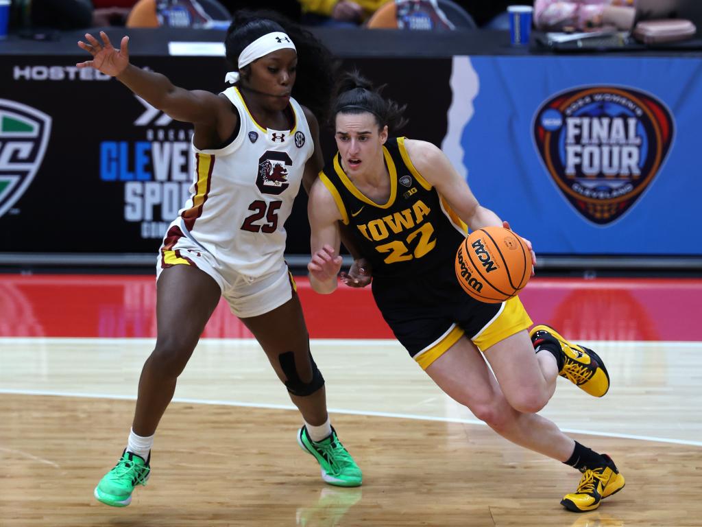 Caitlin Clark #22 of the Iowa Hawkeyes dribbles around Raven Johnson #25 of the South Carolina Gamecocks in the second half during the 2024 NCAA Women's Basketball Tournament National Championship at Rocket Mortgage FieldHouse on April 07, 2024 in Cleveland, Ohio.  