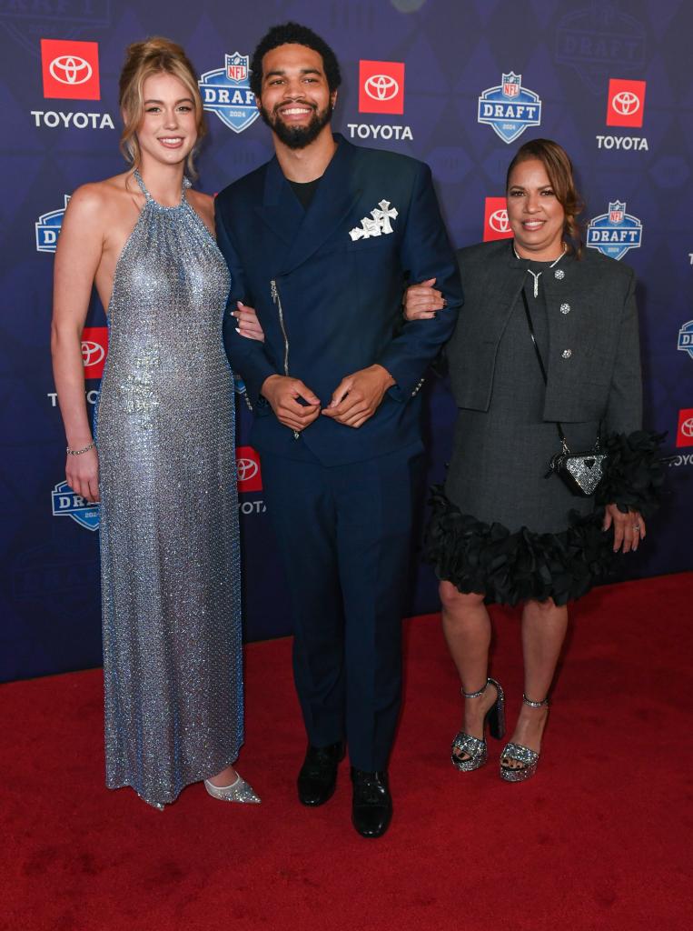 Caleb Williams (C) with  attends the 2024 NFL Draft with his girlfriend Alina Thyregod and mother Dayna Price at the Fox Theatre on April 25, 2024 in Detroit, Michigan. 