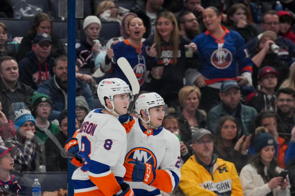 New York Islanders defenseman Noah Dobson (8) celebrates scoring a goal with defenseman Alexander Romanov (28) in the game against the Columbus Blue Jackets