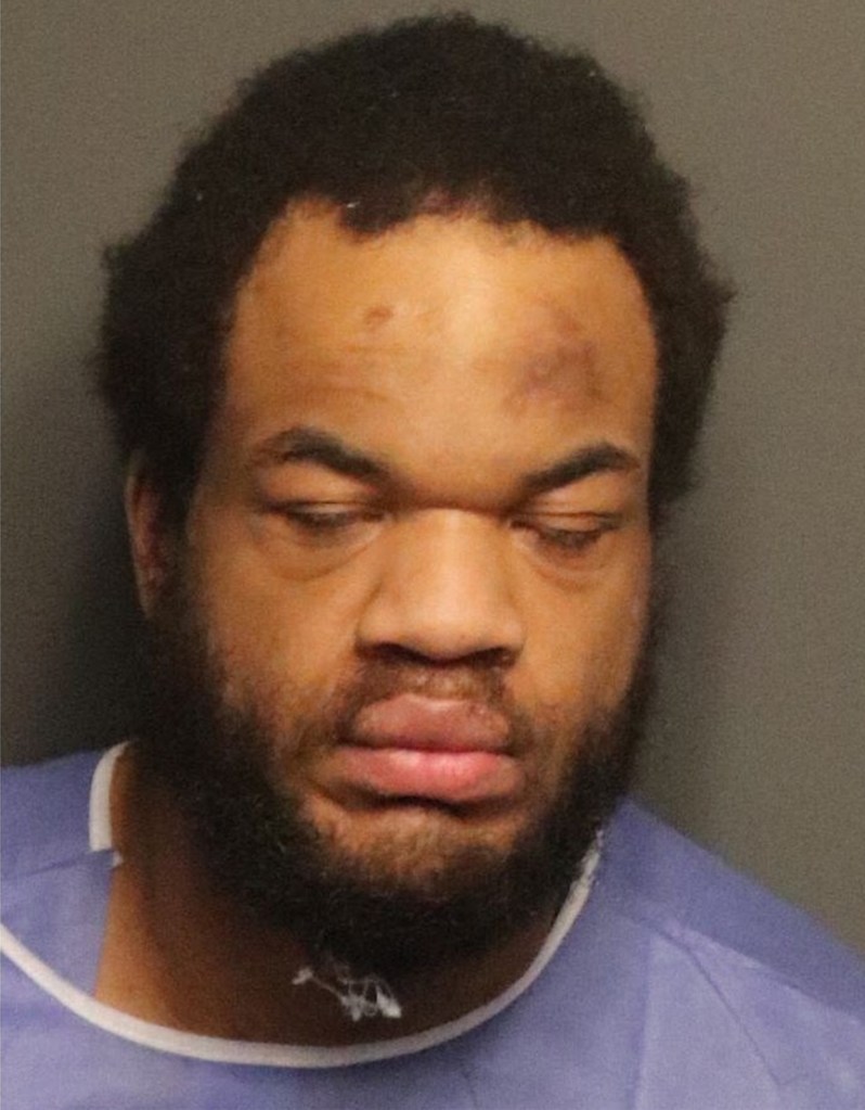 The suspect's mugshot seen from a prior arrest.