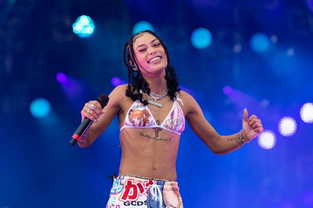 Coi Leray performing onstage at Rolling Loud Miami 2021, holding a microphone