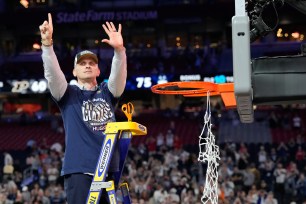 Connecticut Huskies head coach Dan Hurley cuts the basketball net winning the Men's NCAA national championship game against the Purdue Boilermakers at State Farm Stadium in Glendale on April 8, 2024.