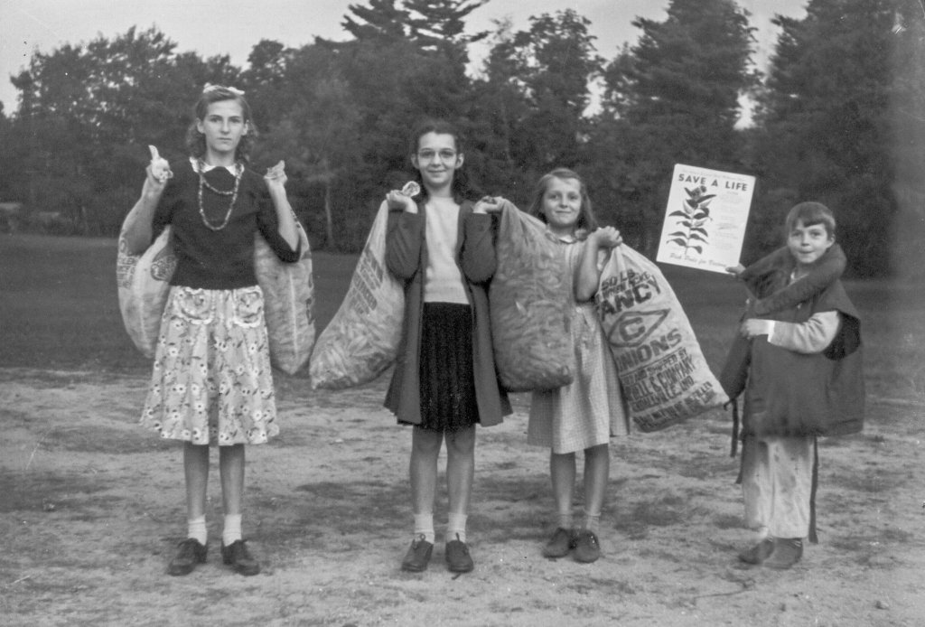 Kids holding bags of milkweed pod