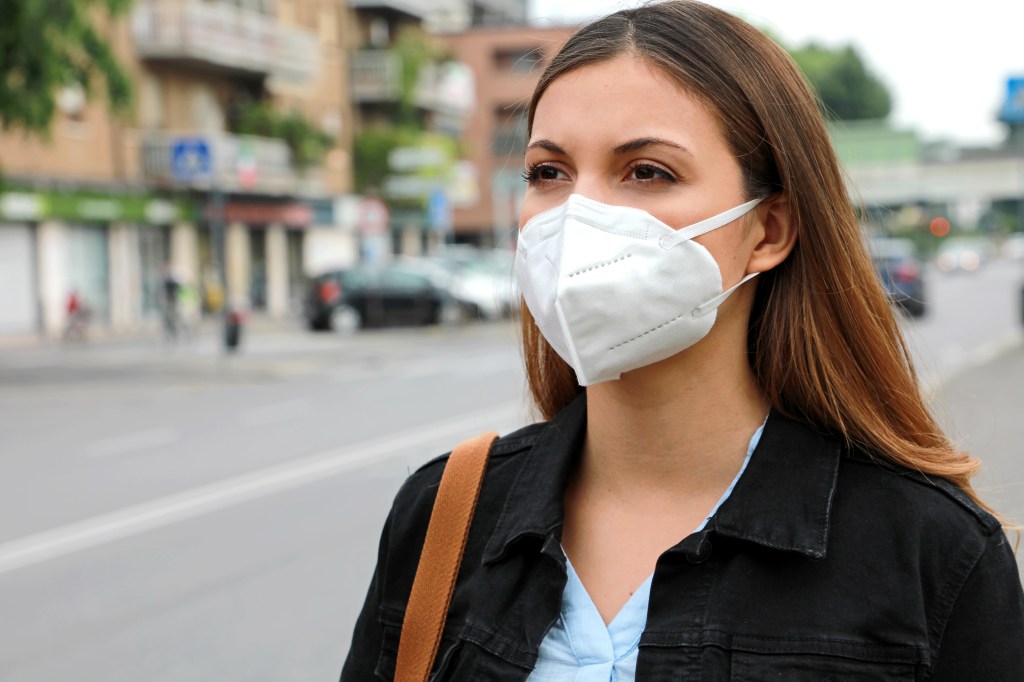 Woman outside wearing a mask. 