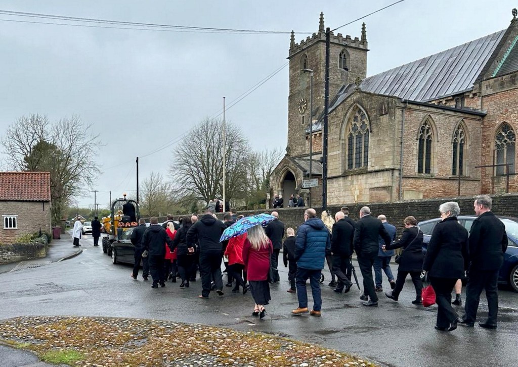 Dave Newton's funeral with his coffin in a dumper truck. 