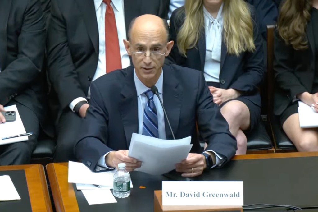 David Greenwald, a Columbia University board member, sitting at a desk during a House Committee hearing on Antisemitism response, alongside another man in a suit