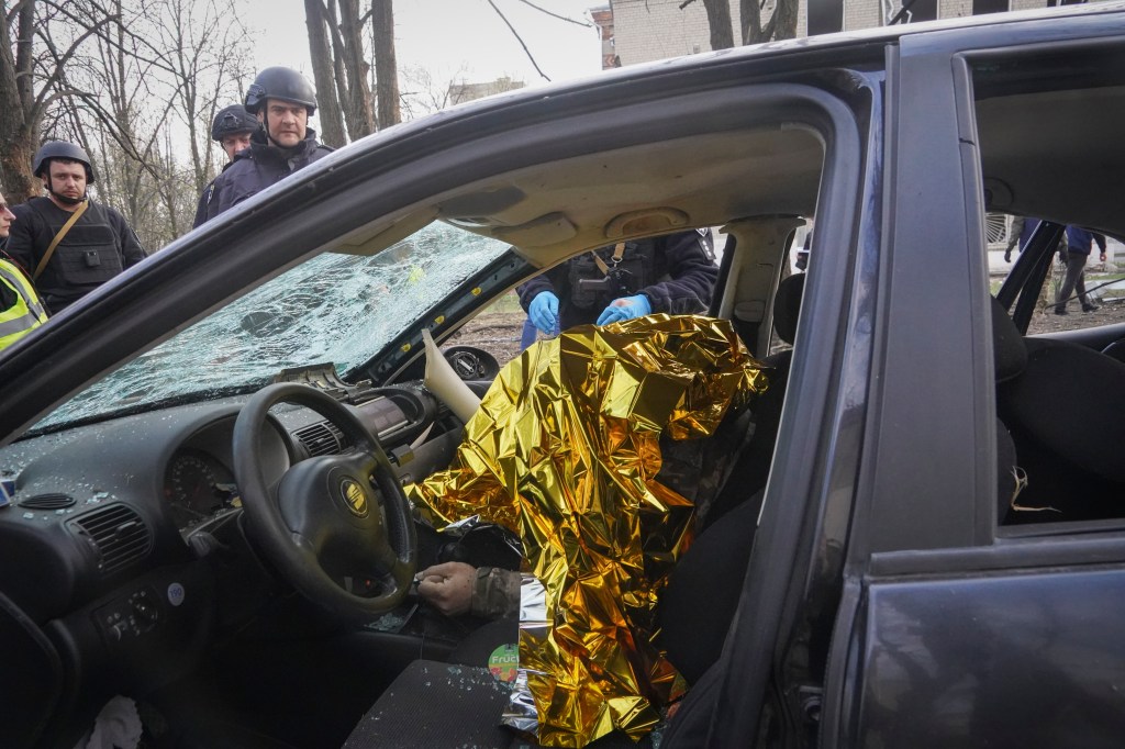 A dead body is seen in a car after a Russian bombing in Kharkiv, Ukraine, Saturday, April 6, 2024.