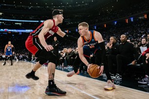 New York Knicks guard Donte DiVincenzo (0) is defended by Miami Heat guard Tyler Herro during the second half of an NBA basketball game on Saturday, Jan. 27, 2024, in New York.